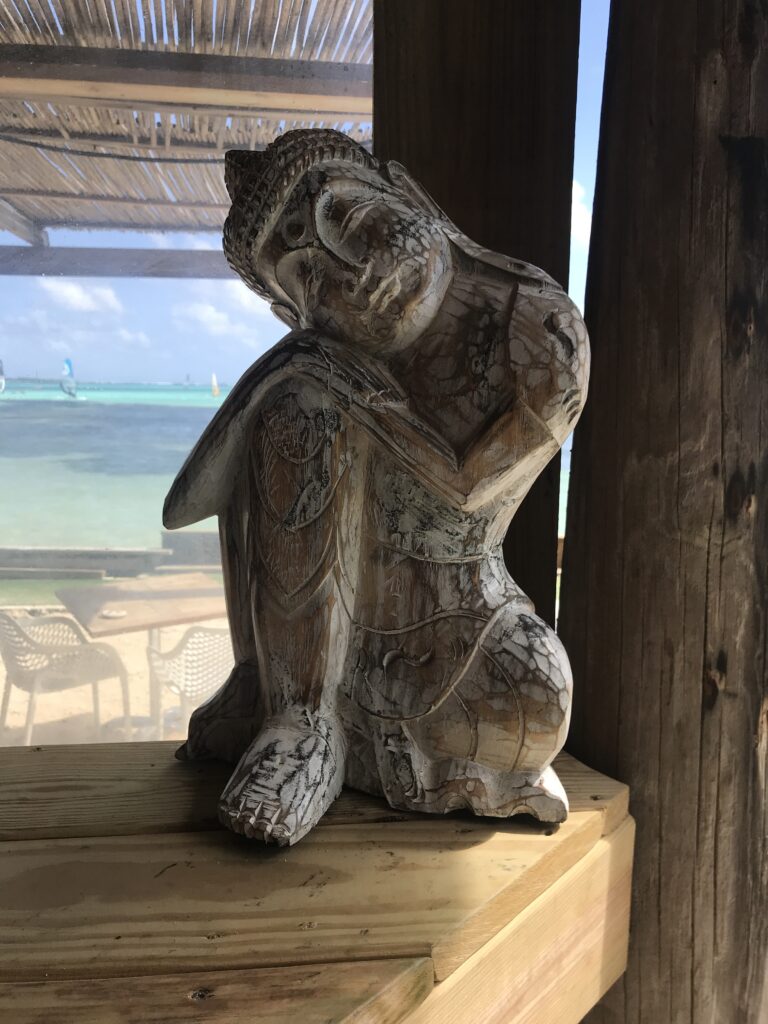 Wooden statue showing the opposite of what most feel when their undergoing workplace stress. 
