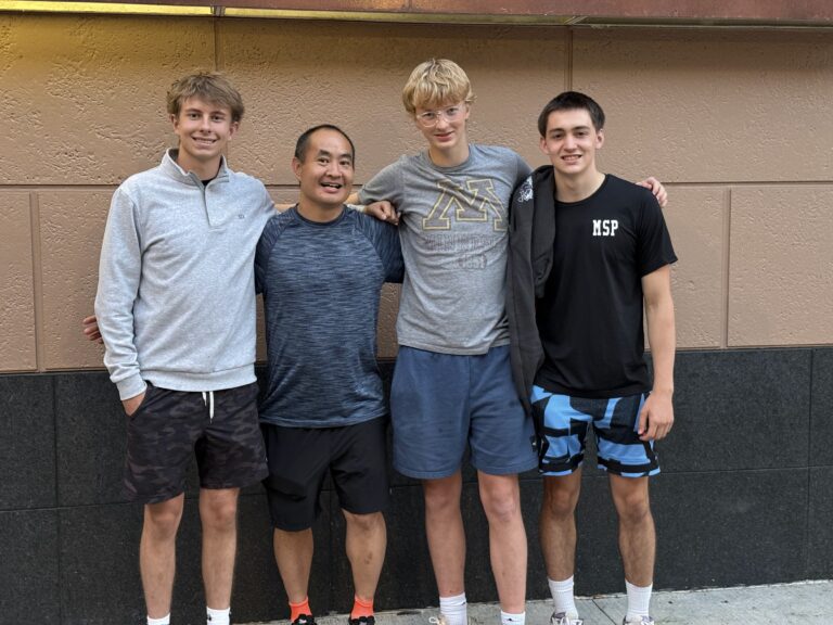 Group of young adults and mentor demonstrating success