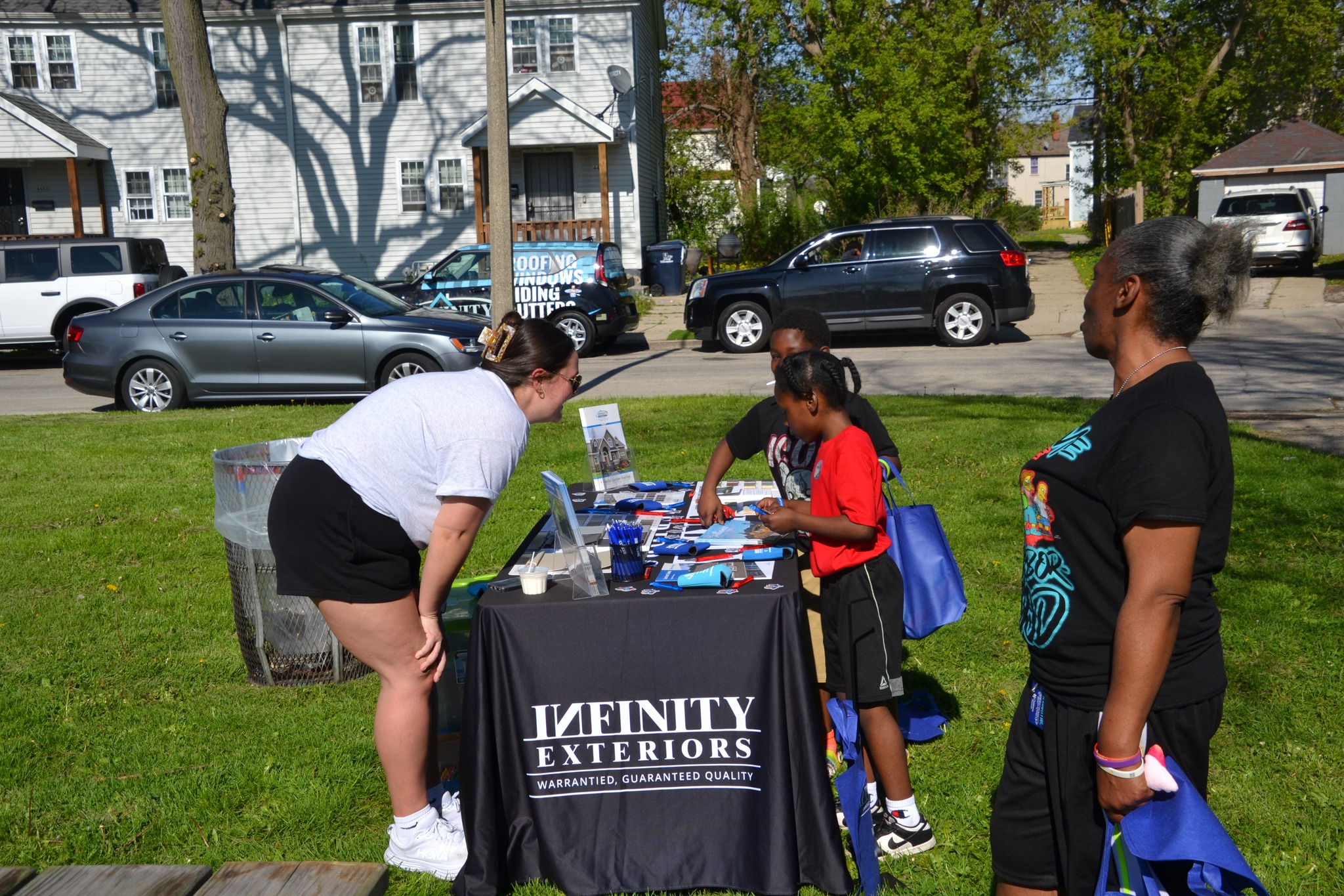Infinity Exteriors team members volunteering and supporting the Brat with a Cop community outreach event.