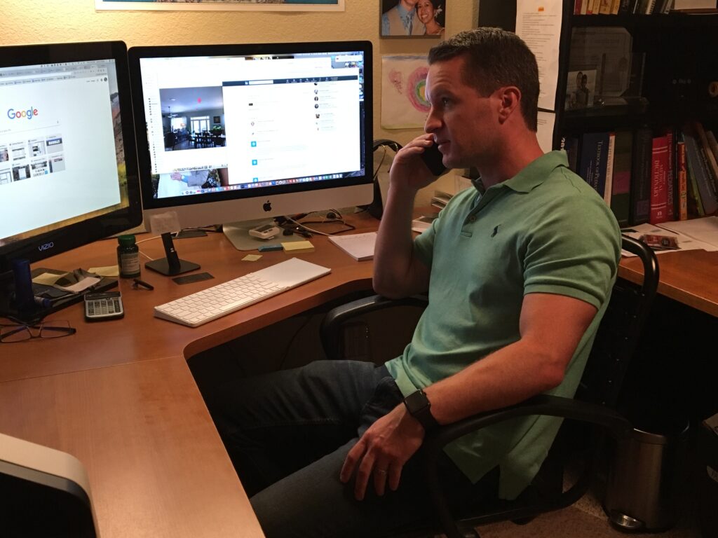 Jeremy Maher speaking on the phone with a client