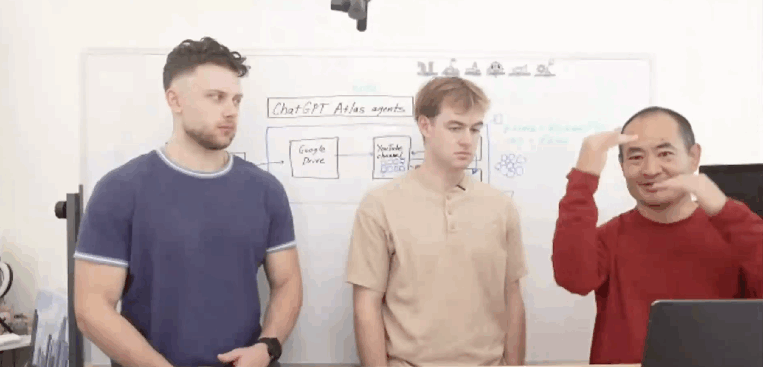 Three team members discussing ChatGPT Atlas agents at the Tai Lopez mastermind workshop