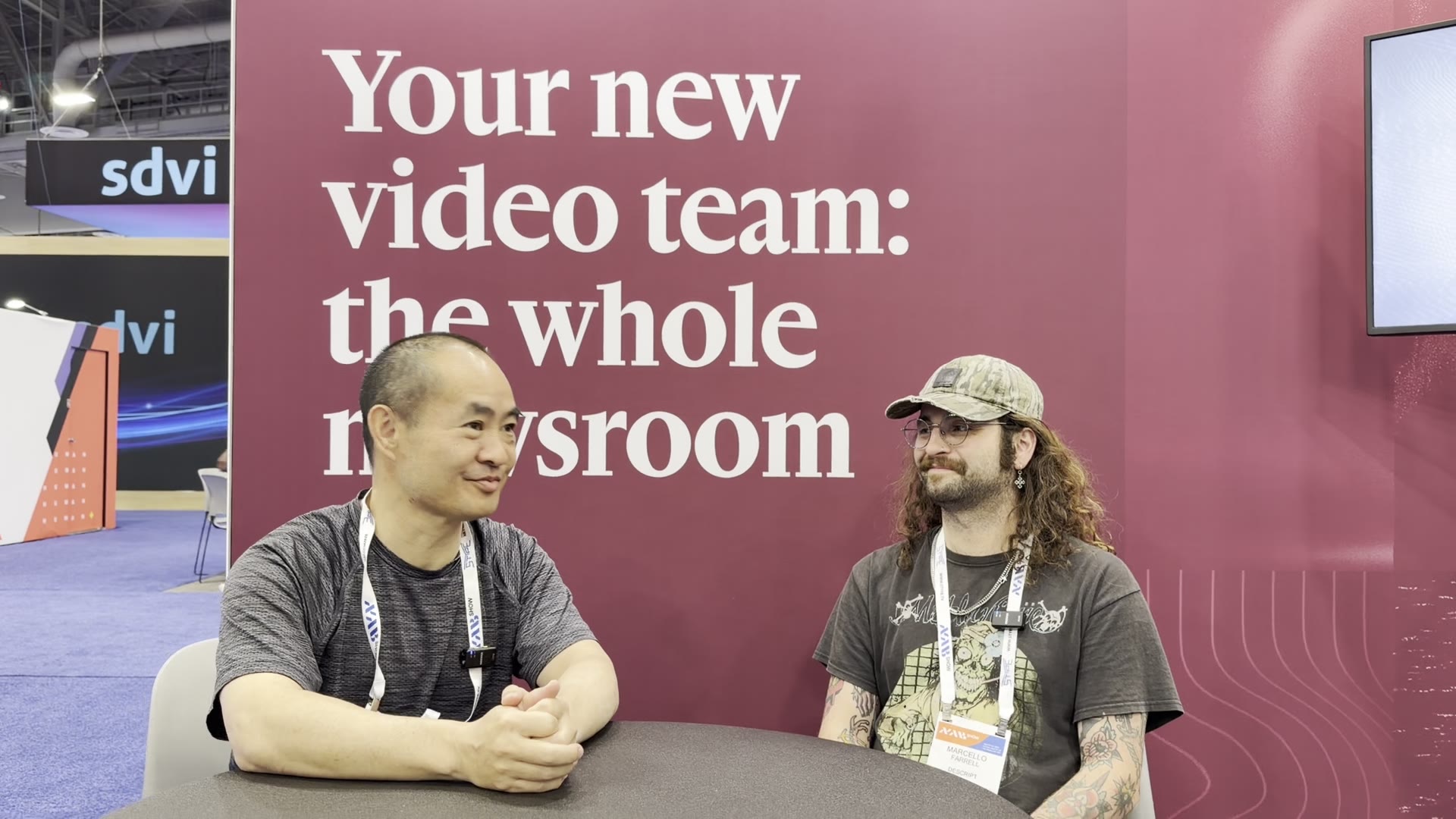 Dennis Yu and Marcello Farrell talking AI video editing at the Descript booth at NAB 2026