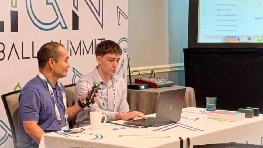 Dennis Yu holding the microphone while Dylan Haugen teaches club directors at the JVA Align Summit