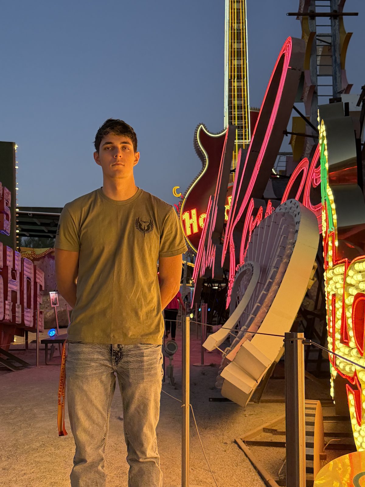 Elias in front of the Hard Rock Cafe guitar neon sign
