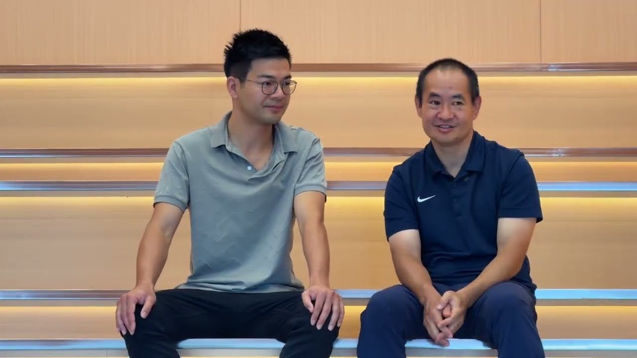 Jack Jiao and Dennis Yu sitting in the stadium-style training room at Rowan Appliance's Shenzhen office